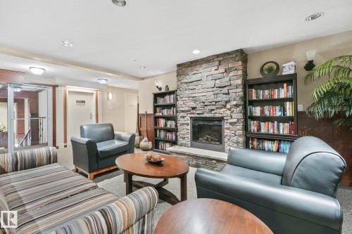 #209 1589 Glastonbury Bv Nw, Edmonton, AB - Indoor Photo Showing Living Room With Fireplace