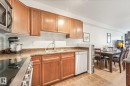 #209 1589 Glastonbury Bv Nw, Edmonton, AB  - Indoor Photo Showing Kitchen With Stainless Steel Kitchen With Double Sink 