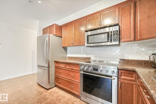#209 1589 Glastonbury Bv Nw, Edmonton, AB - Indoor Photo Showing Kitchen With Stainless Steel Kitchen