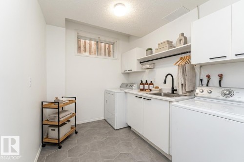 virtually staged - 300 Ferris Way Nw, Edmonton, AB - Indoor Photo Showing Laundry Room