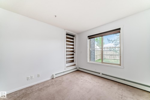 Neutral tone carpeting and white painted walls - 103 3315 James Mowatt Trail Sw, Edmonton, AB - Indoor Photo Showing Other Room