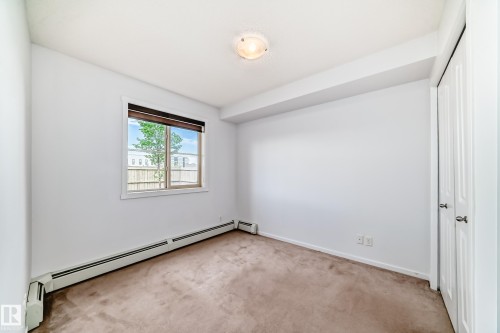 Neutral color palette room featuring carpet flooring - 103 3315 James Mowatt Trail Sw, Edmonton, AB - Indoor Photo Showing Other Room