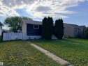 Single-story dwelling featuring a dark blue facade, white trim, and a prominent front walkway - 4823 49 Street, Clyde, AB  - Outdoor 