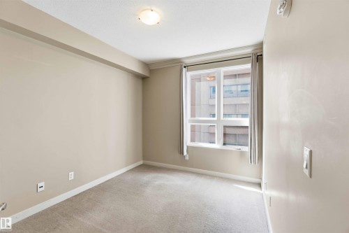 Light-colored carpeting complementing neutral wall tones - #708 9939 109 St Nw, Edmonton, AB - Indoor Photo Showing Other Room