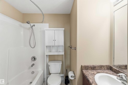 Bathroom featuring a white tub and shower combination with a handheld showerhead - #708 9939 109 St Nw, Edmonton, AB - Indoor Photo Showing Bathroom
