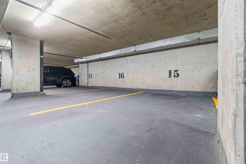 Underground parking space featuring concrete walls, concrete ceiling, and painted floor - #708 9939 109 St Nw, Edmonton, AB - Indoor Photo Showing Garage