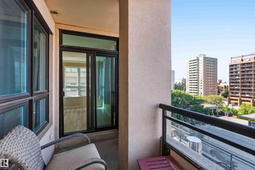 Outdoor balcony with a glass and metal railing, offering urban surroundings - #708 9939 109 St Nw, Edmonton, AB - Outdoor With Balcony With Exterior