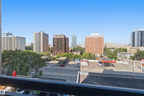 Urban skyline with various high-rise buildings and surrounding commercial establishments under a clear sky - #708 9939 109 St Nw, Edmonton, AB - Outdoor With View