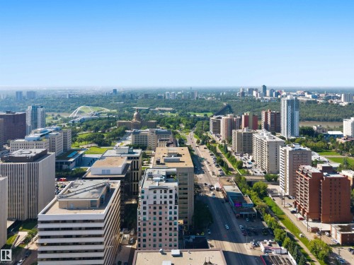 Expansive urban landscape featuring a clear sky, a river, and a blend of high-rise and mid-rise buildings - #708 9939 109 St Nw, Edmonton, AB - Outdoor With View
