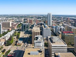Expansive urban landscape with a variety of architectural styles, including contemporary high-rises and established commercial buildings - 