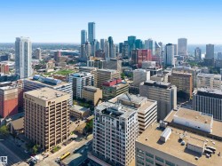 Expansive city skyline featuring a diverse collection of high-rise buildings, including contemporary glass towers and traditional brick structures - 