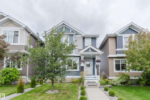 Two-story residential exterior featuring a light blue and gray facade with white trim - 6717 Elston Lane Nw, Edmonton, AB - Outdoor With Facade