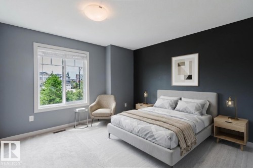 Spacious bedroom featuring light gray carpeting, a large white-framed window, and a contemporary ceiling light fixture - 6717 Elston Lane Nw, Edmonton, AB - Indoor Photo Showing Bedroom