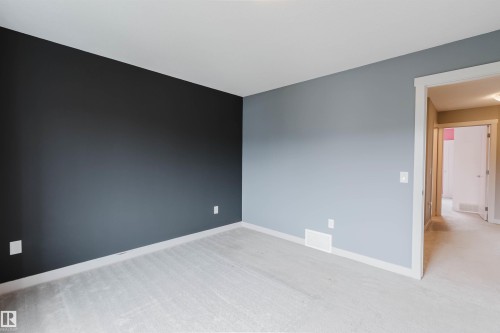 Neutral-toned carpeting throughout - 6717 Elston Lane Nw, Edmonton, AB - Indoor Photo Showing Other Room