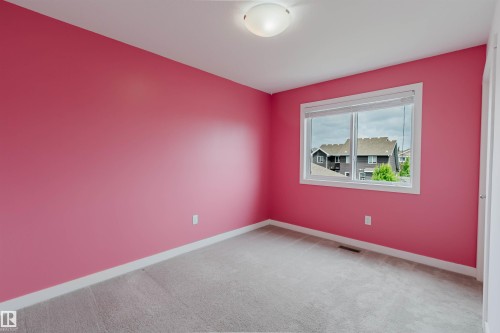 Room featuring a single window with blinds, a flush mount ceiling light, light-colored carpeting, and painted walls with white baseboards - 6717 Elston Lane Nw, Edmonton, AB - Indoor Photo Showing Other Room