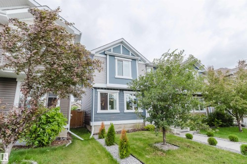 Two-story residence featuring light blue and gray siding with white trim - 6717 Elston Lane Nw, Edmonton, AB - Outdoor