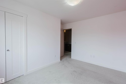 Neutral wall tones with light-toned carpeting - 6717 Elston Lane Nw, Edmonton, AB - Indoor Photo Showing Other Room