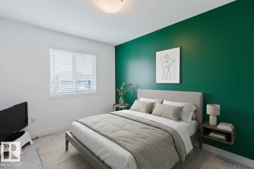 Accent wall in a deep green hue - 6717 Elston Lane Nw, Edmonton, AB - Indoor Photo Showing Bedroom