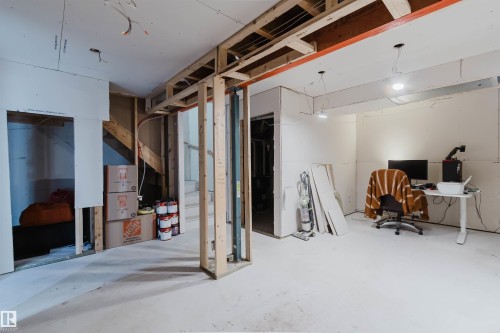 Unfinished interior space with exposed wooden framing and partial drywall installation - 6717 Elston Lane Nw, Edmonton, AB - Indoor