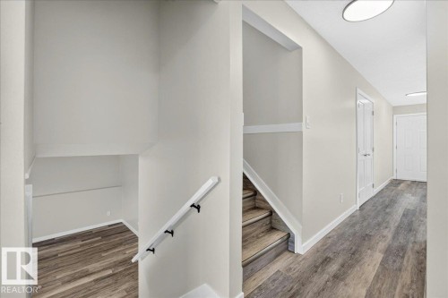 Entryway with wood-finish flooring, white baseboards, and neutral wall paint - 4212 32 Avenue Nw, Edmonton, AB - Indoor Photo Showing Other Room