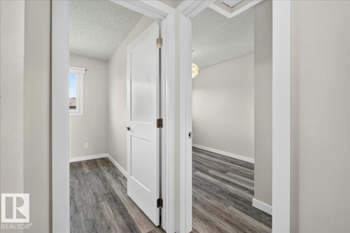 Interior doorways showcasing modern panel doors and wood-finish flooring - 4212 32 Avenue Nw, Edmonton, AB - Indoor Photo Showing Other Room