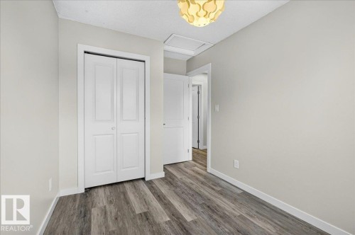 Interior room featuring wood-finish flooring and light-toned walls - 4212 32 Avenue Nw, Edmonton, AB - Indoor Photo Showing Other Room