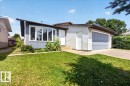 Ranch-style residence featuring a prominent bay window, attached garage with a gray door, and white siding - 4212 32 Avenue Nw, Edmonton, AB  - Outdoor 