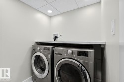 Dedicated laundry area featuring a light-toned countertop, recessed lighting, and a neutral color palette - 