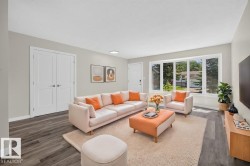 Spacious living area featuring contemporary wood-finish flooring, a bright bay window, and light gray wall tones - 