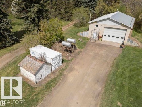 Detached garage structure with a large overhead door and a metal roof - 23242 Hwy 14, Rural Strathcona County, AB 