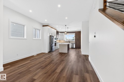 Open concept living area with wood-finish flooring, recessed lighting, and white walls - 5308 103A Avenue, Edmonton, AB - Indoor Photo Showing Kitchen