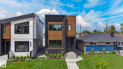 Contemporary exterior featuring a flat roofline, wood-finish siding, and dark trim windows - 5308 103A Avenue, Edmonton, AB - Outdoor With Facade