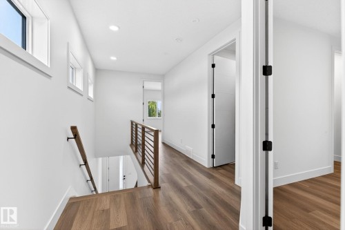 Upper-level hallway with wood-finish flooring, recessed lighting, and white walls - 5308 103A Avenue, Edmonton, AB - Indoor Photo Showing Other Room