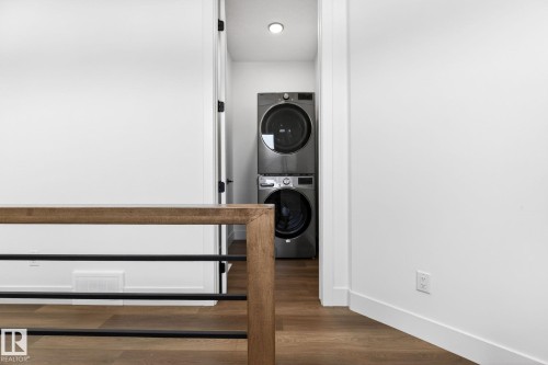 Wood-finish flooring with crisp white walls and baseboards - 5308 103A Avenue, Edmonton, AB - Indoor Photo Showing Laundry Room