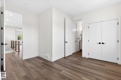 Wood-finish flooring throughout, complemented by white trim and neutral wall tones - 