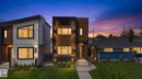 Modern two-story facade featuring dark-framed windows, a flat roofline, vertical panel siding, exterior wall sconces, and a neatly manicured lawn - 5308 103A Avenue, Edmonton, AB  - Outdoor With Facade 