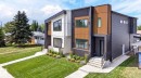 Modern duplex exterior featuring contrasting dark and light siding, wood-look accents, black-framed windows, and a manicured lawn with a concrete pathway - 5308 103A Avenue, Edmonton, AB  - Outdoor 