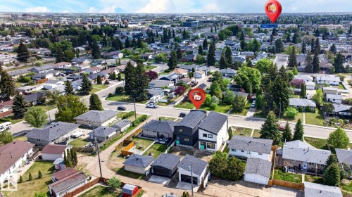 Contemporary townhomes featuring contrasting dark and light exteriors, prominent square windows, and a flat roofline - 5308 103A Avenue, Edmonton, AB - Outdoor With View