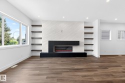 Statement fireplace wall featuring a modern electric fireplace, integrated media console, and flanking open shelving - 