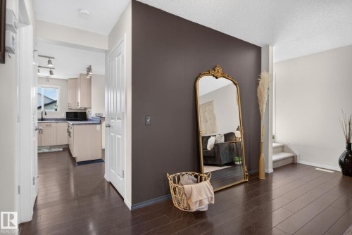 Dark wood-finish flooring extending through the entry and into the kitchen - 191 Brookview Place, Stony Plain, AB - Indoor