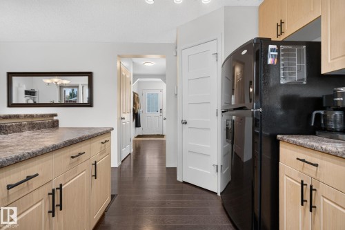 Kitchen featuring light wood-finish cabinetry with black hardware, stone-look countertops, and recessed lighting - 191 Brookview Place, Stony Plain, AB - Indoor Photo Showing Kitchen