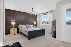 Feature wall with geometric paneling and a modern chandelier - 