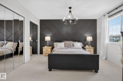 Accent wall with geometric paneling and sconce lighting - 