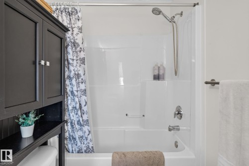 Integrated bathtub and shower combination featuring a white surround and chrome fixtures - 191 Brookview Place, Stony Plain, AB - Indoor Photo Showing Bathroom