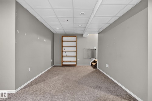 Carpeted lower-level room with suspended acoustic ceiling tiles and recessed lighting - 191 Brookview Place, Stony Plain, AB - Indoor Photo Showing Other Room