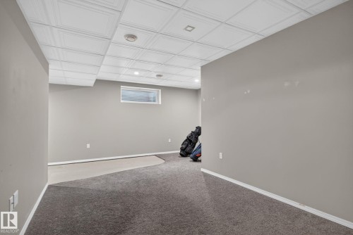 Finished basement area featuring recessed lighting, a drop ceiling, and a high window - 191 Brookview Place, Stony Plain, AB - Indoor