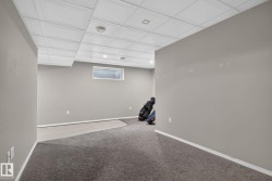 Finished basement area featuring recessed lighting, a drop ceiling, and a high window - 