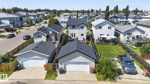 Detached two-story residence featuring a private backyard, rear deck, and a detached two-car garage with an asphalt shingle roof - 191 Brookview Place, Stony Plain, AB - Outdoor