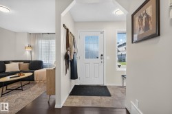 Bright entry with a white paneled door featuring a decorative glass insert - 