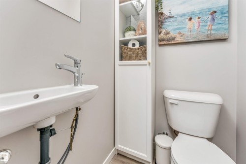 White ceramic wall-mounted sink with a chrome faucet - #25 1530 Tamarack Bv Nw, Edmonton, AB - Indoor Photo Showing Bathroom